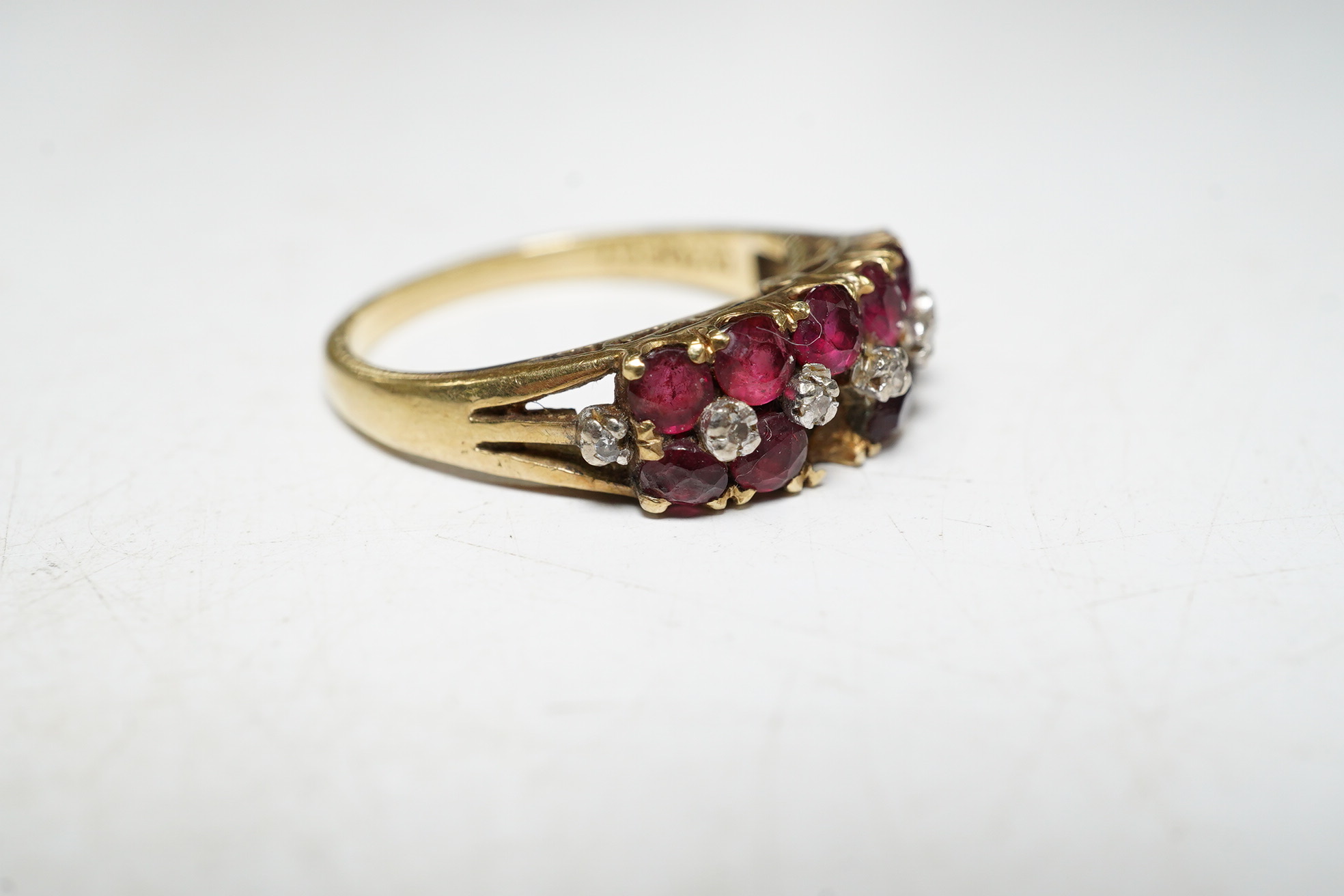 An 18k ruby and diamond set dress ring, one ruby missing, size M, gross 3.7 grams